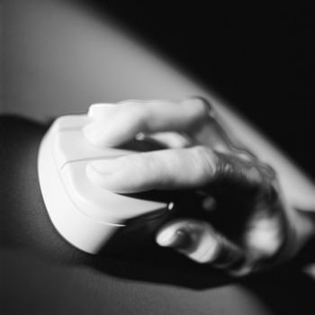 Womans hand on a mouse.