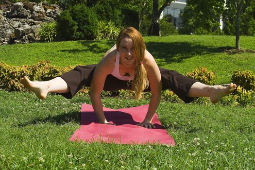 Model carries out a series of yoga positions in the park.