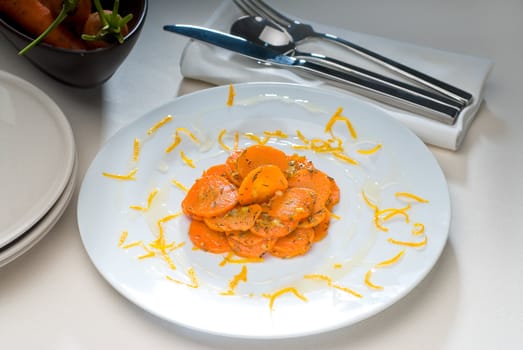 fresh  and healthy Honey glazed carrots on a plate with tyme on top