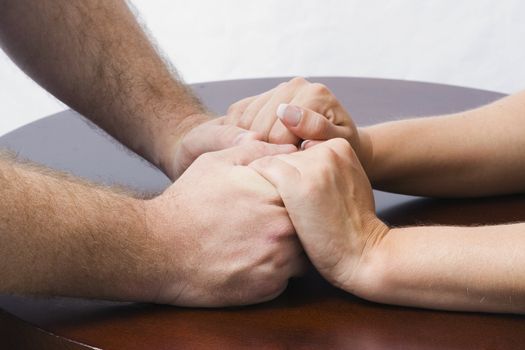 A couple holds hands, reconnecting to what the once had.