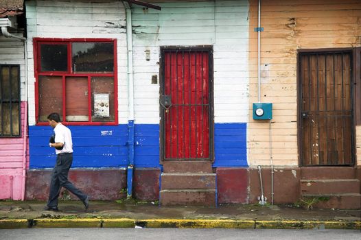 Colorful buildings and man on the street in Alajuela Costa Rica