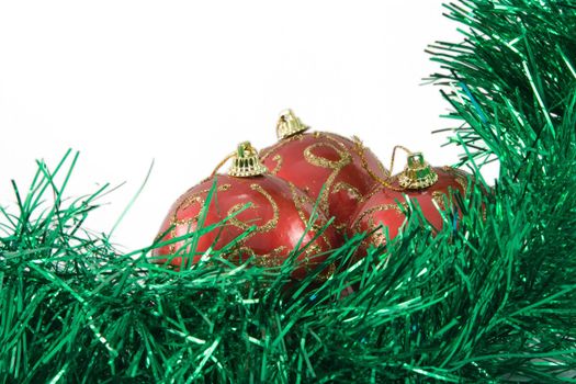 Three spheres in a tinsel on a white background