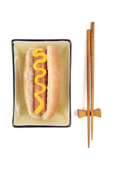 East Meets West - Hot Dog and Chopsticks Isolated on a White Background.