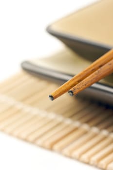 Abstract Chopsticks and Bowls Isolated on a White Background.
