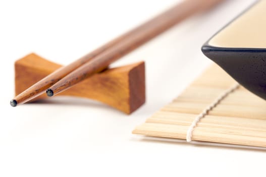 Abstract Chopsticks and Bowls Isolated on a White Background.
