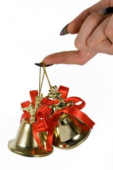 Two handbells hanging on a finger. White background.