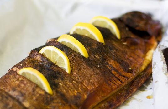 very appetizing smoked trout with segments of lemon