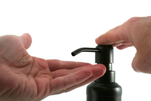 A hand soap dispenser being used, isolate on a white background.