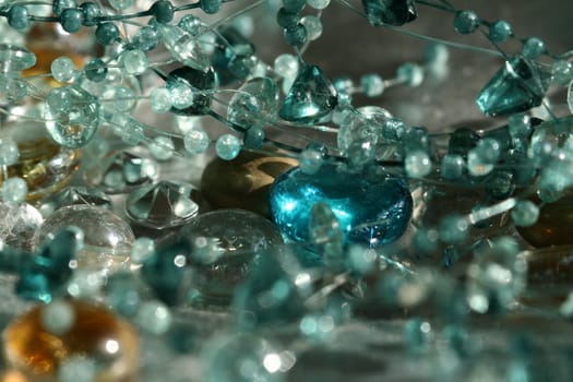 A close up of decorative beads and rhinestones in a dish.