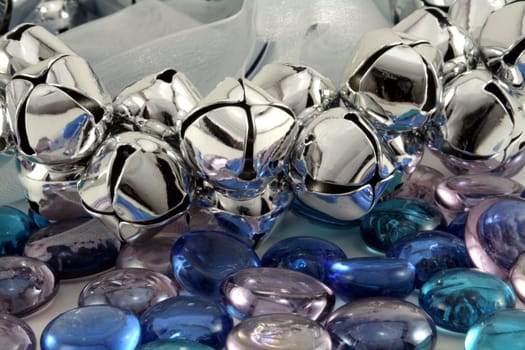 Silver Christmas bells with blue glass stones.