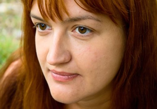 Portrait of the woman against green plants