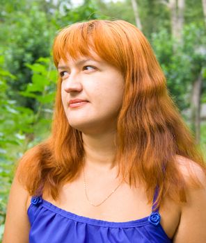 Portrait of the red woman on green background
