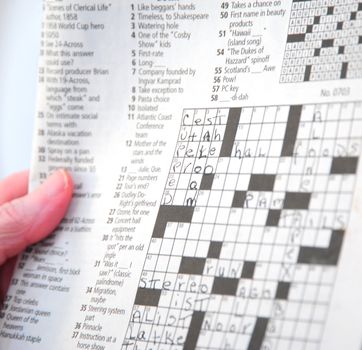 Woman working a crossword puzzle.