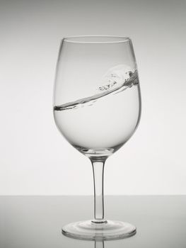 A water wave into a wine glass.