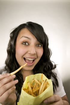 Portrait of a teenage Latina with fries.