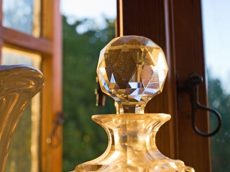 Decorative antique crystal glass bottle by a window