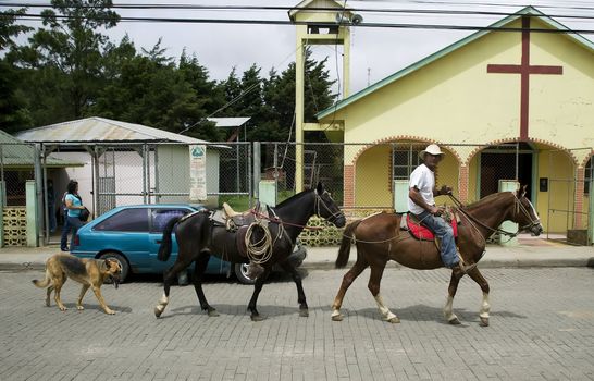 Man on a horse followed by dog in Santa Elena Costa Rica