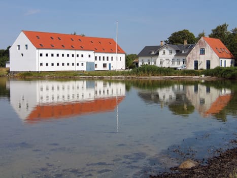 Mansion big farmhouse reflected in the sea Funen Denmark