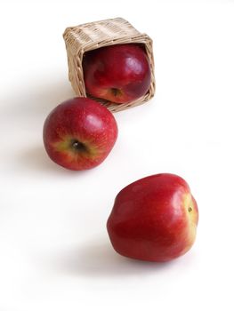 Red apples and basket on a white background 