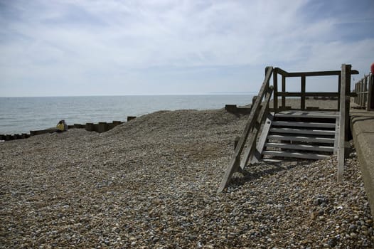 A pebble beach with wooden steps