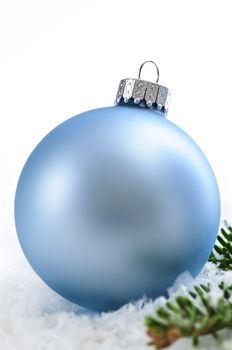 Blue Christmas decoration in snow with pine branches