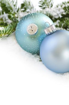 Two Christmas decoration in snow with pine branches