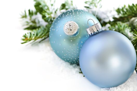 Two Christmas decoration in snow with pine branches