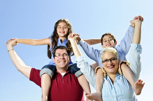 Happy family having fun giving shoulder rides