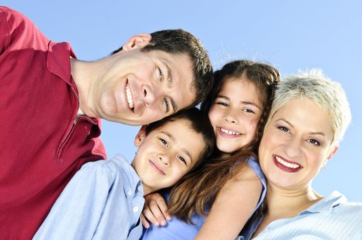 Portrait of happy family of four smiling