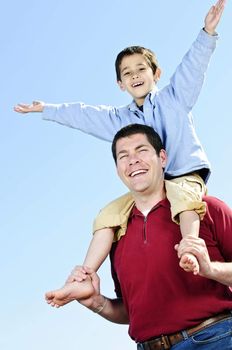 Portrait of father giving shoulder ride to son