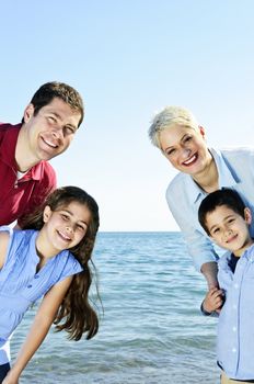 Welcoming happy family of four at lake