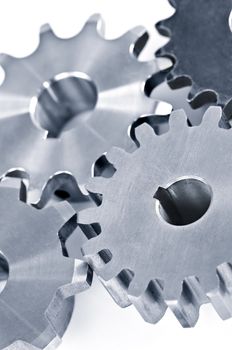 Interlocking industrial metal gears isolated on white
