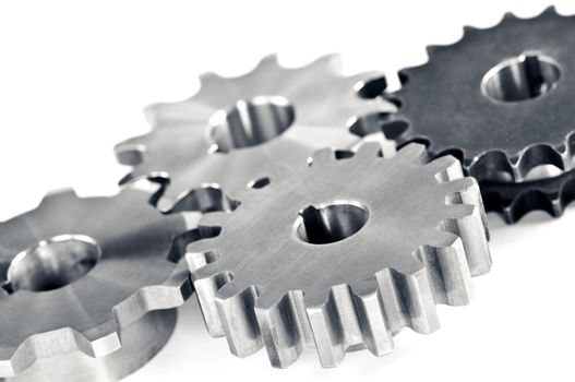 Interlocking industrial metal gears isolated on white