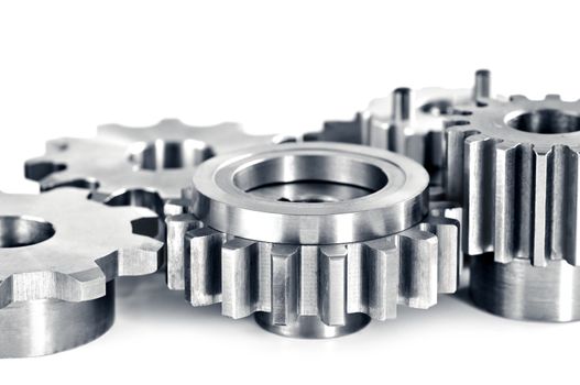 Interlocking industrial metal gears isolated on white