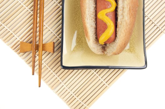 East Meets West - Hot Dog and Chopsticks Isolated on a White Background