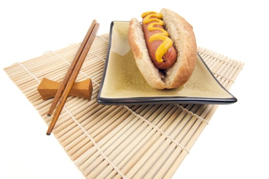 East Meets West - Hot Dog and Chopsticks Isolated on a White Background