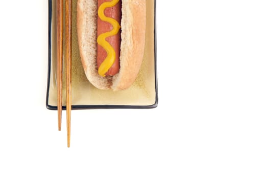 East Meets West - Hot Dog and Chopsticks Isolated on a White Background