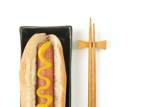 East Meets West - Hot Dog and Chopsticks Isolated on a White Background