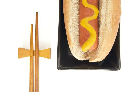 East Meets West - Hot Dog and Chopsticks Isolated on a White Background