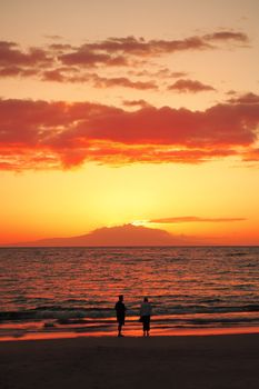 Couple walking at sunset on Wailea Beach east Maui, Hawaii, USA