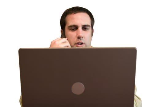 A business man working from home with his cell phone and laptop. 