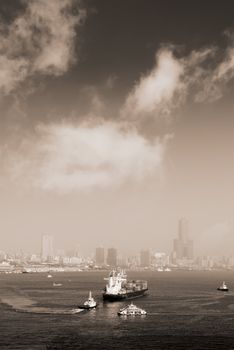 Cityscape of harbor with large freighter and beautiful skyscraper in modern city.