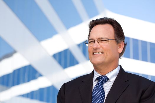 Handsome Businessman Smiling in Suit and Tie Outside of Corporate Building.