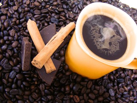 coffee cup with beans,chocolate and cinnamon