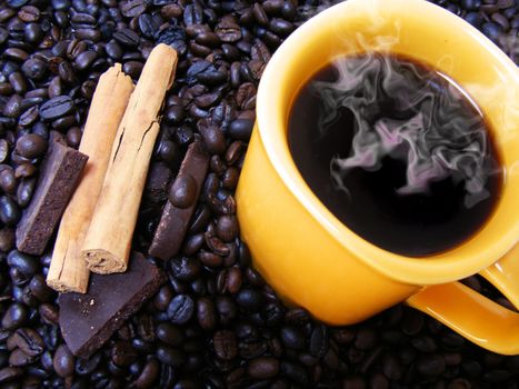 coffee cup with beans,chocolate and cinnamon