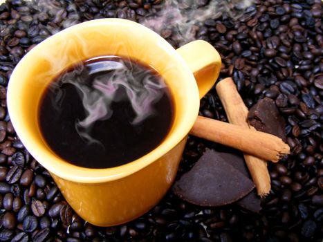 coffee cup with beans,chocolate and cinnamon