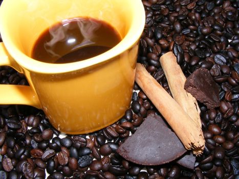 coffee cup with beans,chocolate and cinnamon