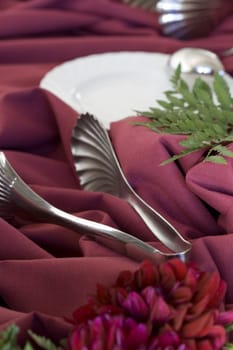 silver utensils for wedding food with white plate