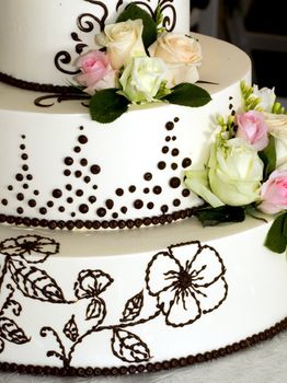  closeup details of beautiful tiered wedding cake with flowers