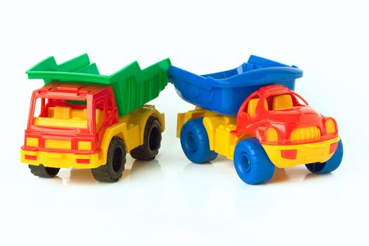 Two toy trucks, isolated on a white background.